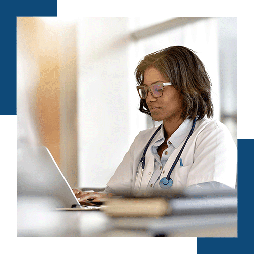 physician facing left asking questions on computer